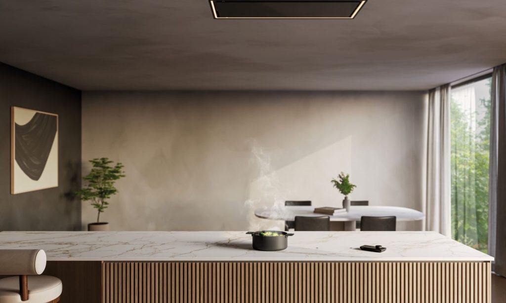 Cuisine design sur mesure avec plaque à induction invisible NOVY Undercover intégrée dans un îlot central avec plan de travail effet marbre